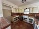 Quaint kitchen features terra cotta flooring and a stainless-steel sink at 807 Lucille Ave, Nokomis, FL 34275