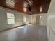 A well-lit living room with a ceiling fan, neutral walls, and tile flooring at 807 Lucille Ave, Nokomis, FL 34275