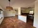 Bright living room with terra cotta flooring, open to the kitchen with a brick-counter bar at 807 Lucille Ave, Nokomis, FL 34275