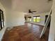 An empty Living Room featuring terra cotta floors and large windows at 807 Lucille Ave, Nokomis, FL 34275