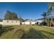 Wide view of the large fenced yard with an outbuilding and lush grass at 8475 Chesapeake Ave, North Port, FL 34291