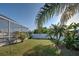 Lush backyard showcasing a fenced-in yard, tropical plants, and ample space for outdoor activities at 8475 Chesapeake Ave, North Port, FL 34291