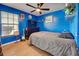 Bedroom boasting bright blue walls, built in shelves, and ample natural light at 8475 Chesapeake Ave, North Port, FL 34291