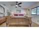 Comfortable bedroom featuring a stylish bed, ceiling fan, window and charming decor at 8475 Chesapeake Ave, North Port, FL 34291