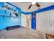 Bedroom boasting bright blue walls, built in shelves, and ample closet space at 8475 Chesapeake Ave, North Port, FL 34291