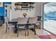 Dining area featuring views of the pool and a table with seating for four under decorative shelving at 8475 Chesapeake Ave, North Port, FL 34291