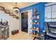 Welcoming front entry with bright blue accent wall and decorative shelving at 8475 Chesapeake Ave, North Port, FL 34291