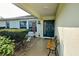 Welcoming front porch featuring a dark-colored front door, bench seating, and decorative accents at 8475 Chesapeake Ave, North Port, FL 34291