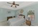 Cozy bedroom with wicker furniture, ceiling fan, and soft blue walls at 9204 L Pavia Blvd # 9204, Venice, FL 34292