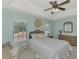 Cozy bedroom features wicker bed frame, ceiling fan, and lots of natural light at 9204 L Pavia Blvd # 9204, Venice, FL 34292