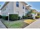 A charming two-story condo with well-manicured landscaping, under a clear blue sky, creates a welcoming exterior view at 9204 L Pavia Blvd # 9204, Venice, FL 34292