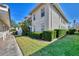 Exterior of the property showcasing the lawn, windows, hedges, and landscaping at 9204 L Pavia Blvd # 9204, Venice, FL 34292