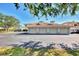 View of the detached garages showing several doors and a parking lot at the front of the building at 9204 L Pavia Blvd # 9204, Venice, FL 34292