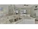 Kitchen bar counter and sink area featuring stainless fixtures and white cabinets at 9204 L Pavia Blvd # 9204, Venice, FL 34292