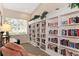 Bright and inviting library room with floor-to-ceiling bookshelves and comfortable seating at 9204 L Pavia Blvd # 9204, Venice, FL 34292