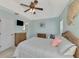 Bright main bedroom features wicker furniture and television set at 9204 L Pavia Blvd # 9204, Venice, FL 34292