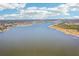 An aerial view of the water and foliage with clouds in the sky at 9790 Parkwood Ct, Seminole, FL 33777