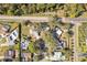 An aerial view showing a home and its neighborhood with mature trees and easy access to nearby roads at 9790 Parkwood Ct, Seminole, FL 33777