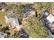 Aerial view of a charming home with a screened-in pool surrounded by mature trees and lush landscaping at 9790 Parkwood Ct, Seminole, FL 33777