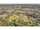 Expansive aerial view of a residential neighborhood with lush greenery and waterfront properties on canal at 9790 Parkwood Ct, Seminole, FL 33777