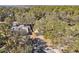 Aerial view of a residential neighborhood with mature trees, manicured lawns and a central tree line at 9790 Parkwood Ct, Seminole, FL 33777