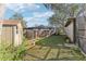 Spacious backyard featuring lush greenery, a bird bath, a storage shed, and partial fencing at 9790 Parkwood Ct, Seminole, FL 33777