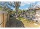 Fenced backyard featuring lush greenery, a screened-in pool, mature trees and a storage shed at 9790 Parkwood Ct, Seminole, FL 33777