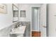 Stylish bathroom featuring gray tile and hardwood flooring at 9790 Parkwood Ct, Seminole, FL 33777