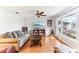 Bright and airy living room featuring hardwood floors, a large window and a ceiling fan at 9790 Parkwood Ct, Seminole, FL 33777