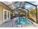 Beautiful in-ground pool and attached spa are enclosed in a screen to keep pests out at 9790 Parkwood Ct, Seminole, FL 33777