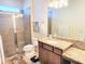 Bathroom featuring a granite countertop, tiled shower with glass doors, and modern fixtures at 13892 Alafaya St, Venice, FL 34293