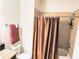 Bathroom featuring a tiled shower, dark wood vanity, and granite countertop at 13892 Alafaya St, Venice, FL 34293