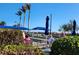 Community bocce ball court with players, palm trees, and an umbrella providing shade for players at 13892 Alafaya St, Venice, FL 34293