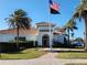 Clubhouse building with American flag, palm trees and neatly manicured lawn at 13892 Alafaya St, Venice, FL 34293