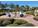 Outdoor fire pit area with white chairs and landscaping at 13892 Alafaya St, Venice, FL 34293