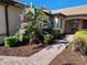 Landscaped front yard with a paver walkway leading to the front door. Includes well-maintained shrubbery at 13892 Alafaya St, Venice, FL 34293