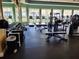 Well-equipped gym with treadmills, weights, and ample natural light at 13892 Alafaya St, Venice, FL 34293