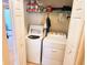 Laundry closet with a washer, dryer, shelving, and storage space at 13892 Alafaya St, Venice, FL 34293