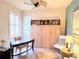 Bright home office with a built-in murphy bed, desk, shutters, and neutral decor at 13892 Alafaya St, Venice, FL 34293