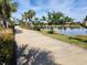 Scenic paved path beside a tranquil lake with lush landscaping at 13892 Alafaya St, Venice, FL 34293