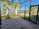 Screened patio with brick flooring overlooking a lake at 13892 Alafaya St, Venice, FL 34293