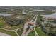 Aerial view of a community entrance, mature palm trees, and water features at 10181 Colubrina Dr, Venice, FL 34293