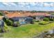 Aerial view of homes with screened in pools overlooking a peaceful lake at 10181 Colubrina Dr, Venice, FL 34293