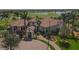 Aerial view of the clubhouse, amenities, landscaping, and golf course community at 10181 Colubrina Dr, Venice, FL 34293