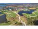 Aerial view of golf course, lakes, and Sarasota National community at 10181 Colubrina Dr, Venice, FL 34293