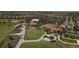 Beautiful aerial shot showcasing the community clubhouse, pool area, golf course, and surrounding residential homes at 10181 Colubrina Dr, Venice, FL 34293