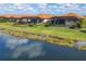 Aerial view of homes with screened in pools overlooking a peaceful lake at 10181 Colubrina Dr, Venice, FL 34293