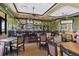 Charming clubhouse bar area featuring a full bar, tables, and a cozy ambiance at 10181 Colubrina Dr, Venice, FL 34293