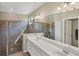 Luxurious bathroom boasting a glass-enclosed shower and dual sink vanity at 10181 Colubrina Dr, Venice, FL 34293