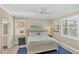 Inviting bedroom featuring plantation shutters, ceiling fan and serene decor at 10181 Colubrina Dr, Venice, FL 34293